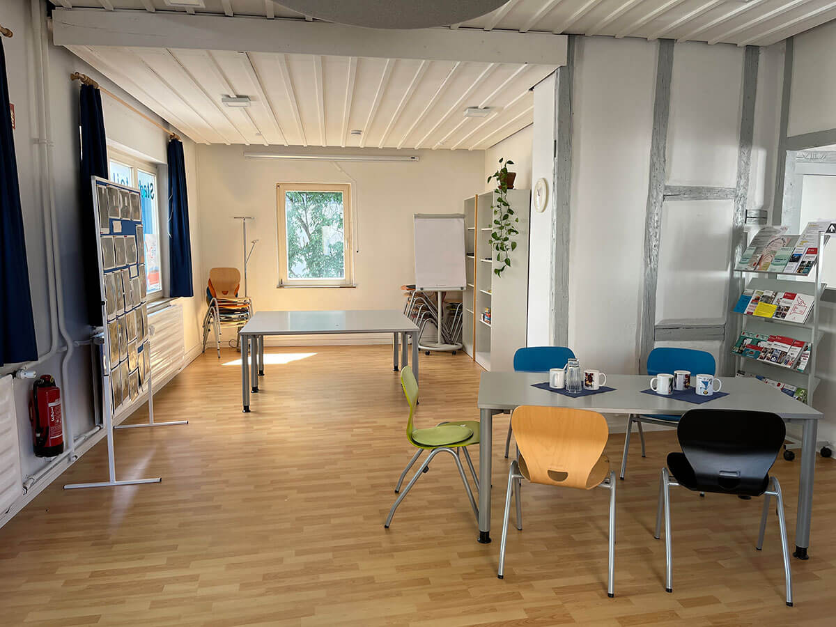 heller, freundlicher Raum mit Tischen und viel Platz