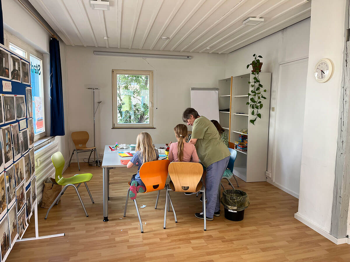 Kinder und Erwachsene basteln an einem Tisch
